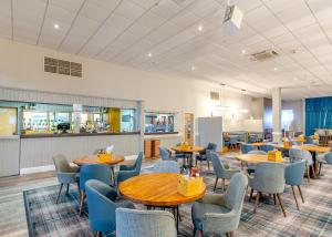 ein Restaurant mit Tischen und Stühlen in einem Raum in der Unterkunft Apartment with Access to Pool Spa & Soft play in Ilfracombe