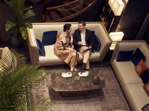 a man and a woman sitting on a couch at Lasagrada Hotel Istanbul in Istanbul