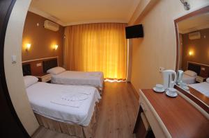Postel nebo postele na pokoji v ubytování Epic Hotel