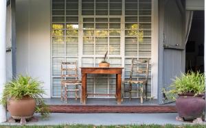 a table and chairs on the front porch of a house at Lavendale on Laing in Barrydale