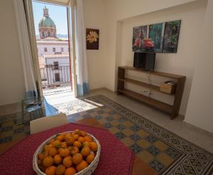 a room with a bowl of oranges on a table at Massimissimo in Palermo