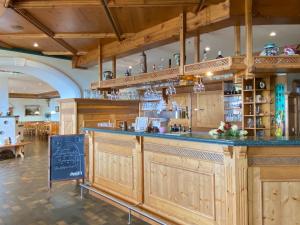 a bar in a restaurant with wooden cabinets at Berg-Panorama-Ferienwohnungen Gut-Lichtenau in Hauzenberg
