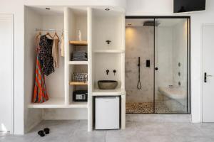a bathroom with a shower and a sink at Manios Suites in Agia Anna Naxos +37 photos