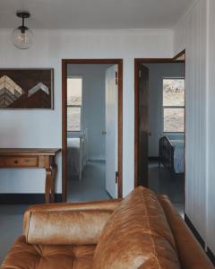 a living room with a couch and a table at Secluded rustic 2-bedroom cabin on nature retreat in Miramonte