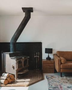 a fireplace in a living room with a couch at Spacious 4-bedroom cabin on secluded private land in Miramonte
