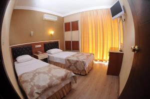 Postel nebo postele na pokoji v ubytování Epic Hotel
