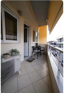a large kitchen with chairs and tables in a room at Home4U apt1, just 8Km from airport in Markopoulo
