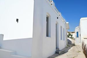 a row of white buildings on a street at Evridiki apartments in Kithnos