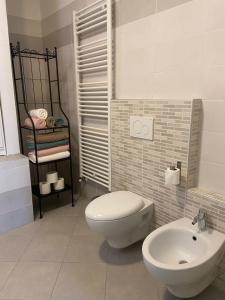 a bathroom with a toilet and a sink at Amalia-Levico Terme Apartment in Levico Terme +11 photos