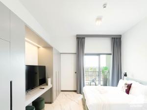 a hotel room with a bed and a television at Mag City 920 Modern Studio Minutes from Downtown in Dubai