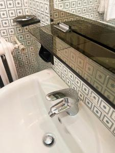 a bathroom sink with a glass counter above it at Casa Borgo in Montasola