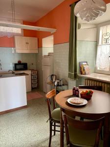 a kitchen with a table with a bowl of fruit on it at Casa Borgo in Montasola +45 photos