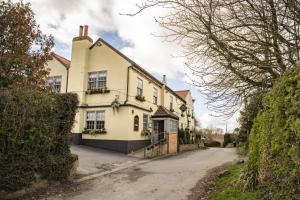 a large yellow house with a driveway at Divico in York