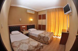 Postel nebo postele na pokoji v ubytování Epic Hotel