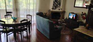 a living room with a table and a dining room at Chambres vacance in Gagos