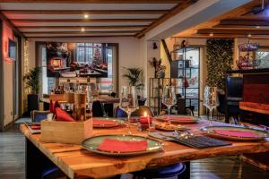 a dining room with a wooden table with red plates at Panorama Suite in Oberammergau