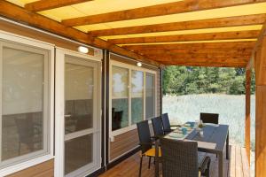 a screened porch with a table and chairs at KRAPEC Beach in Krapets +50 photos