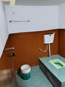 a bathroom with a toilet and a sink at Annada Homestay in Rānchī