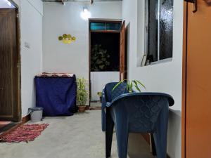 a hallway with a blue chair and a window at Annada Homestay in Rānchī