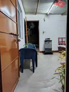 a room with a blue chair and a table at Annada Homestay in Rānchī