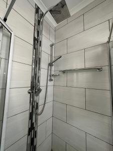 a shower with a glass door in a bathroom at AfriSky guest house in Kempton Park