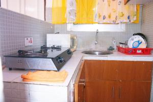 a kitchen with a sink and a counter top at Bamburi Luxury Homes III One bedroom apartment in Bamburi