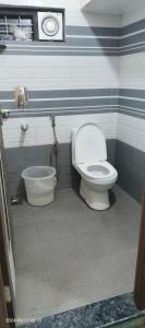 a bathroom with a toilet and a tub at Blue mount stay in Gūdalūr