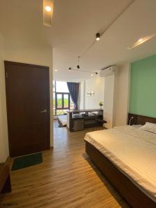 a bedroom with a bed and a desk in it at Sealife Hostel in Quy Nhon