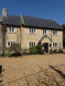 a large brick house with a driveway in front of it at Mulberry House Farm Mulberry Lodge in Chippenham