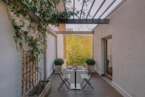 a courtyard with a table and chairs in a building at Opera35 Boutique Hotel in Turin