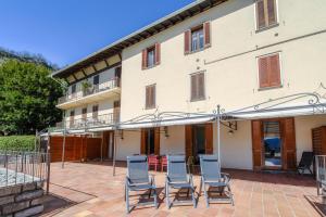 a patio in front of a building with chairs at Crotto Polirolo by "The House Of Travelers" in Cernobbio
