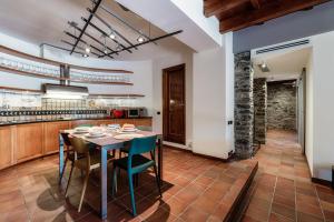 a kitchen with a wooden table and chairs at Crotto Polirolo by "The House Of Travelers" in Cernobbio