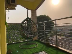 a swing on a balcony with green grass at BSA Douala in Douala