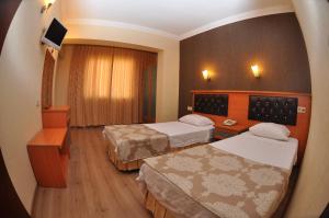 Postel nebo postele na pokoji v ubytování Epic Hotel
