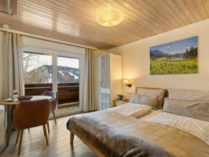 una camera da letto con un letto, un tavolo e una finestra di Frühstückspension Gsenger a Ramsau am Dachstein