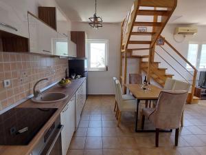 a kitchen with a sink and a table and a staircase at Luxury 3BR Duplex with Pool 2 Mins from Beach in Kumbor in Herceg-Novi