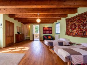a room with three beds and a couch at Agriturismo La Rovere - Casale De Rovere in Cossano Belbo +29 photos
