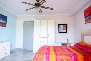 a bedroom with a bed and a ceiling fan at Vista Segária, Playa Deveses in Denia