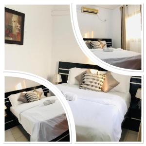 two beds in a room with a mirror at BSA Douala in Douala