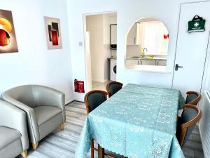 a dining room with a table and a chair at Modern Stylish 4Bed 2 Bath in Pitsea, Basildon Essex 2 Free Carpark in Nevendon