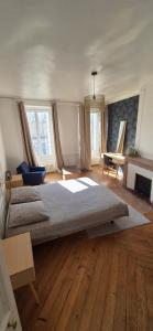 a bedroom with a large bed in a room at Belle maison de ville in Alençon