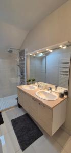 a bathroom with two sinks and a large mirror at Belle maison de ville in Alençon +31 photos