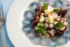 a plate of food with seafood on a table at Hotel Albatros in Ischia