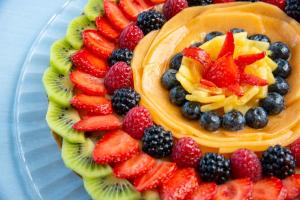 a fruit salad on a plate with fruit on it at Hotel Albatros in Ischia