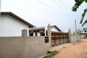 a building with a fence in front of it at Toosonj Guest House in Guwahati