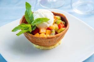 a bowl of vegetables and ice cream on a plate at Hotel Albatros in Ischia