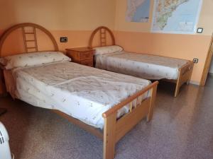 a room with two beds and a map on the wall at Piso in Castalla