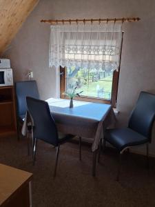 a dining room table with two chairs and a window at Kapitänskoje in Breege +12 photos