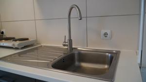 a kitchen sink with a faucet on top of it at MK Apartments Delmenhorst 1 - Free Wifi - Free Parking - nähe HBF in Delmenhorst