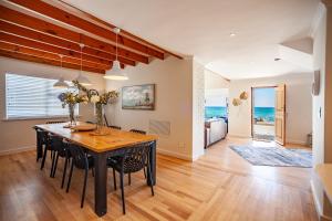 a dining room with a table and chairs at SUNNYSIDE- 5 Bedroom Beach House, Bloubergstrand in Bloubergstrand
